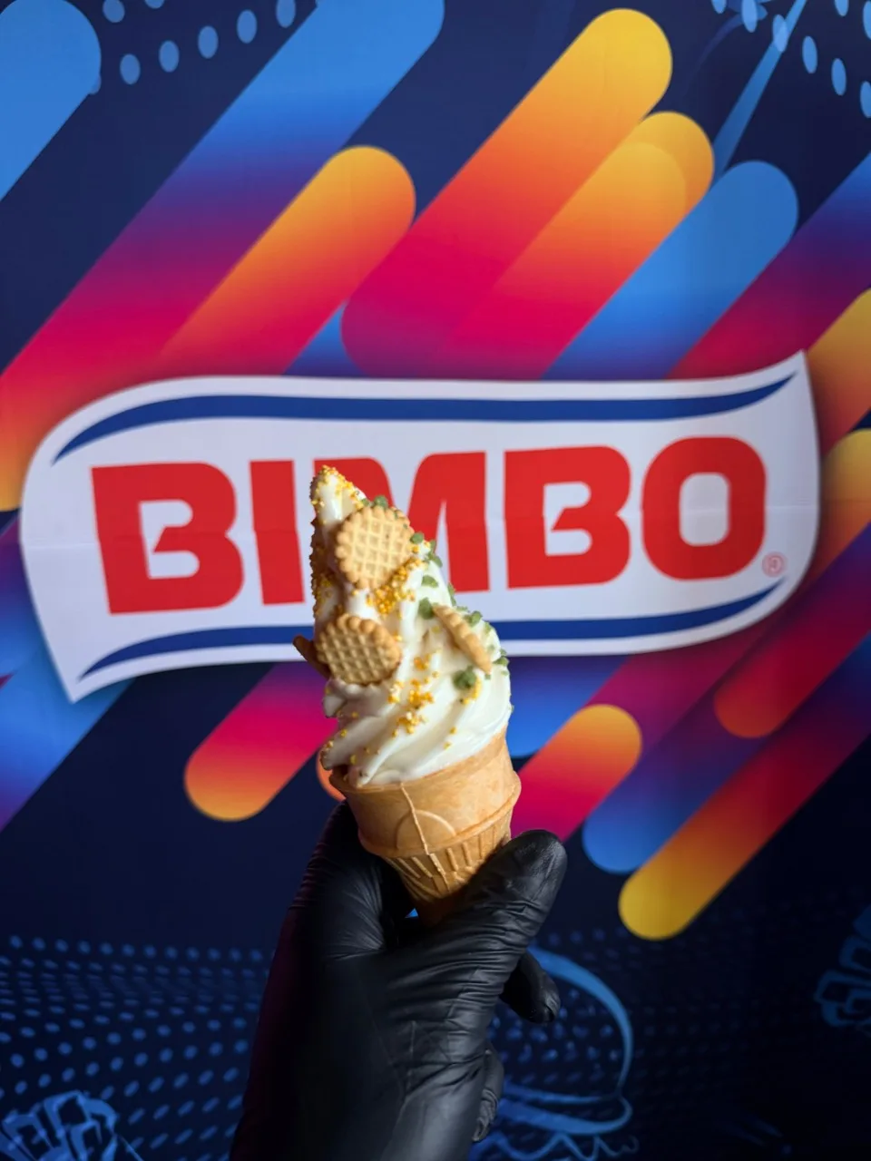 Helado servido en cono con galletas frente al fondo de Bimbo